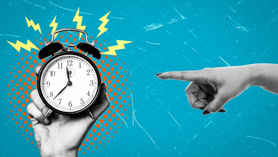 Hand pointing at alarm clock