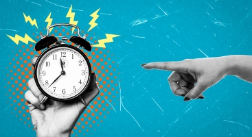 Hand pointing at alarm clock