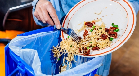 Scraping food into bin