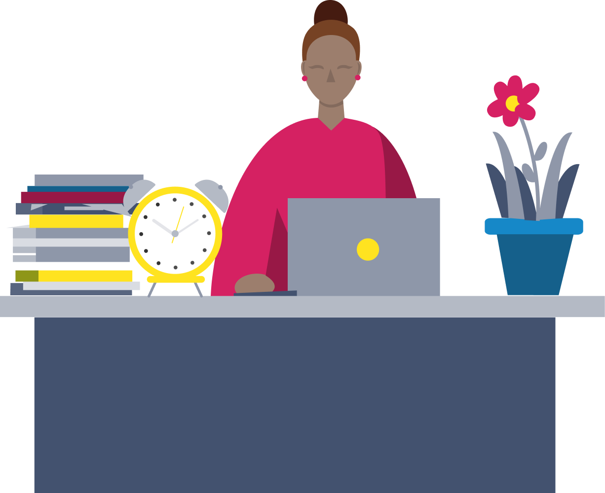 Teacher sat at desk with laptop, books, plant